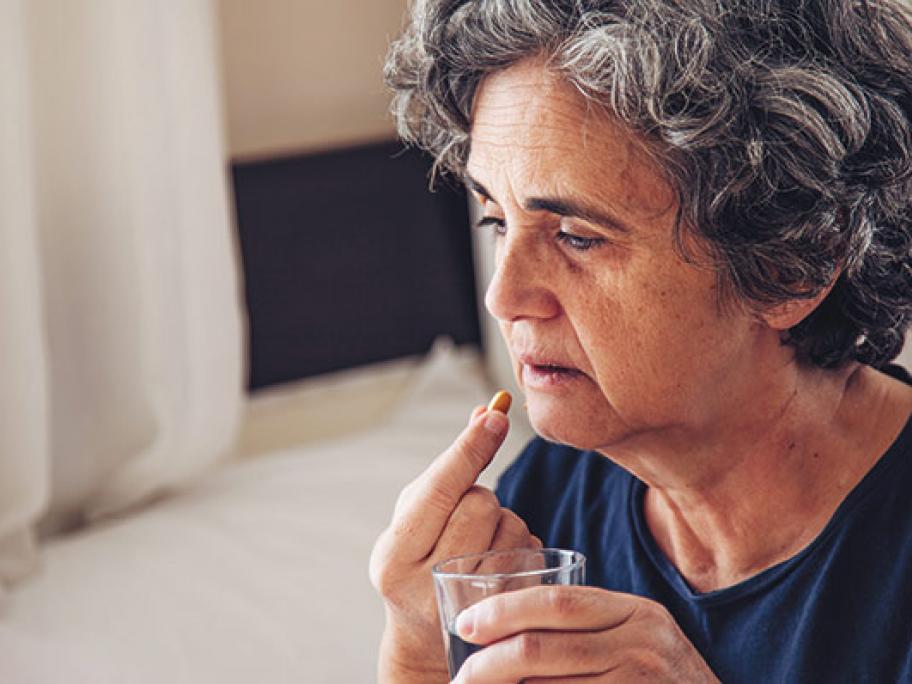 senior woman taking pill