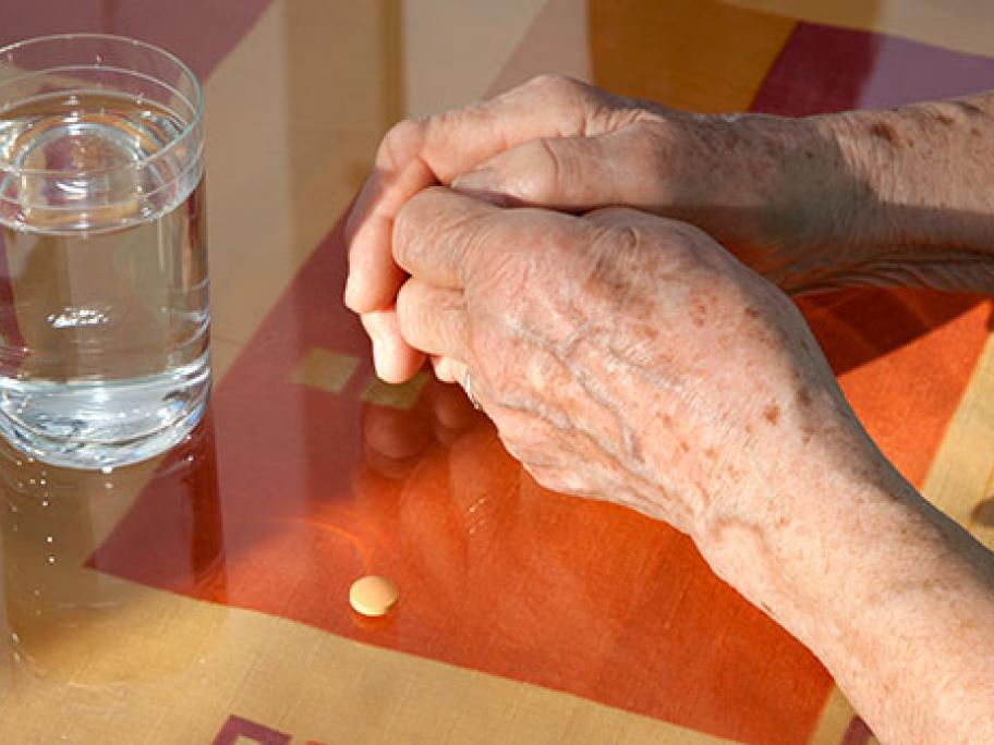 older person with pill
