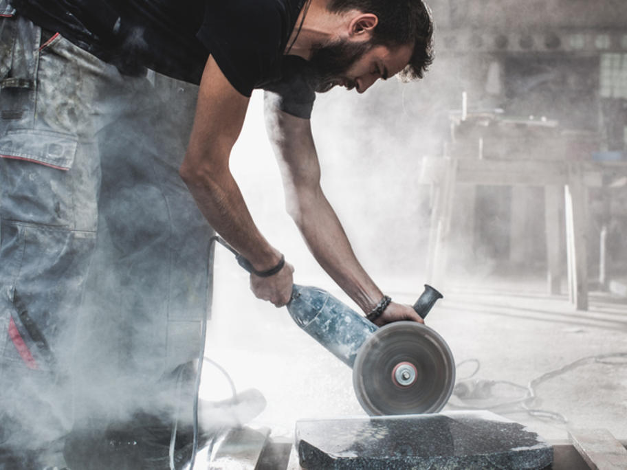 worker withoput PPE cutting stone