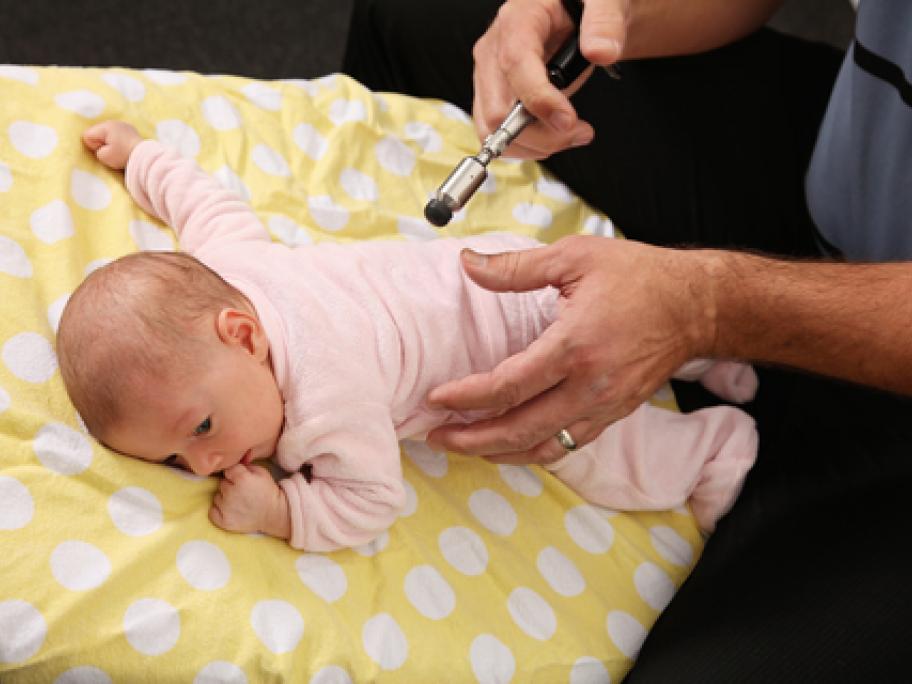 Chiro treating baby