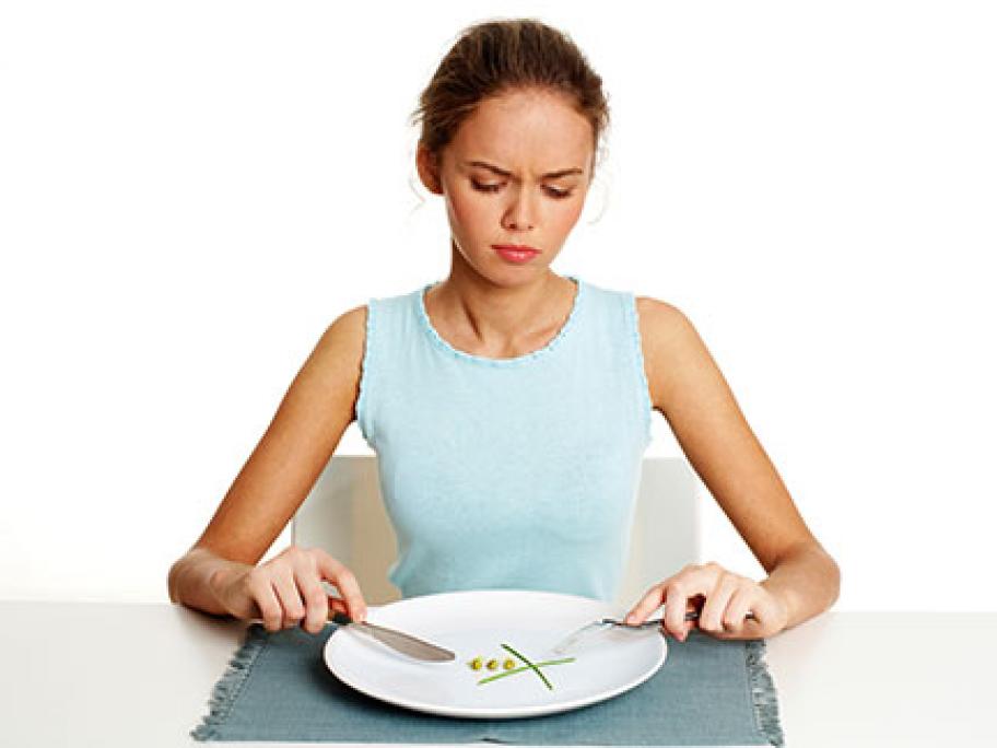 Thin young woman with clean plate