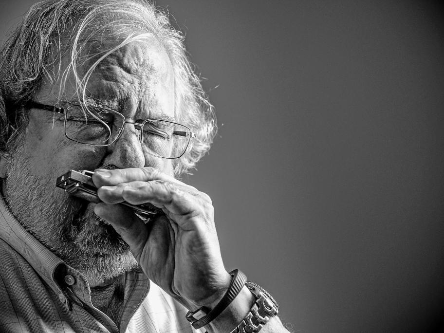 Black and white picture of James Allison playing the harmonica