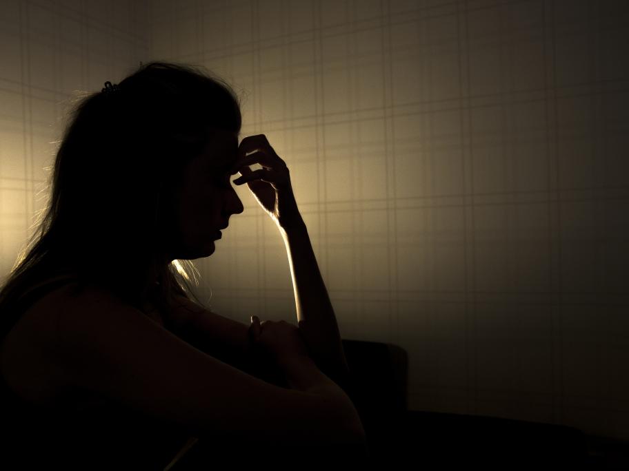 Silhouette of young woman in pain
